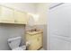Bathroom features a vanity with a light marble countertop, tiled walls, and ample storage at 233 Beeney Se Rd, Port Charlotte, FL 33952