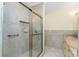 Bathroom featuring a shower with a glass sliding door and safety bars at 233 Beeney Se Rd, Port Charlotte, FL 33952