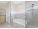 Well-lit bathroom showcasing a shower, bathtub, and updated cabinets at 233 Beeney Se Rd, Port Charlotte, FL 33952