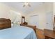 Comfortable bedroom with hardwood floors and large windows with curtains at 233 Beeney Se Rd, Port Charlotte, FL 33952