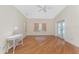 Bedroom featuring hardwood floors, a decorative lamp, and natural light at 233 Beeney Se Rd, Port Charlotte, FL 33952