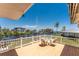 Enjoy outdoor dining on this home's deck overlooking a tranquil waterfront at 233 Beeney Se Rd, Port Charlotte, FL 33952