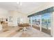 Bright dining area features water views, tile flooring, ceiling fan, and table with access to screened porch at 233 Beeney Se Rd, Port Charlotte, FL 33952