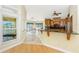 A sunlit dining area features large windows with water views and an adjacent modern kitchen at 233 Beeney Se Rd, Port Charlotte, FL 33952