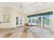 A stylish dining area with panoramic waterfront views, large sliding glass doors, and tile flooring at 233 Beeney Se Rd, Port Charlotte, FL 33952