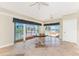 A formal dining area with waterfront views, a ceiling fan, and access to the outdoor deck at 233 Beeney Se Rd, Port Charlotte, FL 33952