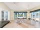 Waterfront dining area features travertine floors, abundant natural light, and access to an outdoor space at 233 Beeney Se Rd, Port Charlotte, FL 33952