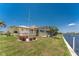 Waterfront home featuring a spacious screened lanai and meticulous landscaping at 233 Beeney Se Rd, Port Charlotte, FL 33952