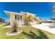 A beautiful home with a well-manicured lawn, covered porch, and inviting curb appeal at 233 Beeney Se Rd, Port Charlotte, FL 33952