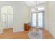 Bright foyer featuring hardwood floors, chandelier, and double doors leading outside at 233 Beeney Se Rd, Port Charlotte, FL 33952