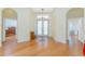 Spacious foyer with hardwood floors leading to various rooms, showcasing an open and airy design at 233 Beeney Se Rd, Port Charlotte, FL 33952
