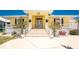 Charming home featuring a welcoming front entrance with white railing and meticulously landscaped yard at 233 Beeney Se Rd, Port Charlotte, FL 33952