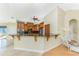 A bright kitchen boasts custom cabinetry, granite countertops, stainless steel appliances, and a breakfast bar at 233 Beeney Se Rd, Port Charlotte, FL 33952