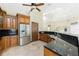A spacious kitchen features granite countertops, stainless steel appliances, custom wood cabinets, and ample storage at 233 Beeney Se Rd, Port Charlotte, FL 33952