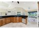 A gourmet kitchen featuring custom wood cabinets, granite countertops, and modern stainless steel appliances at 233 Beeney Se Rd, Port Charlotte, FL 33952