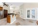 Open kitchen with granite countertops, stainless steel appliances, custom wood cabinetry, and views of dining area at 233 Beeney Se Rd, Port Charlotte, FL 33952
