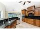 An elegant kitchen boasts custom cabinetry, a breakfast bar with granite countertops, and stainless steel appliances at 233 Beeney Se Rd, Port Charlotte, FL 33952