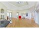 Bright living room with high ceilings, hardwood floors, and abundant natural light from large windows at 233 Beeney Se Rd, Port Charlotte, FL 33952