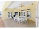 Spacious patio area featuring tile flooring, ceiling fans, and multiple access points to the outdoors at 233 Beeney Se Rd, Port Charlotte, FL 33952