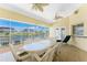 Inviting screened patio with wicker furniture and views of the canal, perfect for outdoor dining and relaxation at 233 Beeney Se Rd, Port Charlotte, FL 33952