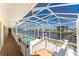 Covered lanai area including furniture and a canal view at 233 Beeney Se Rd, Port Charlotte, FL 33952