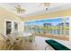 Screened-in patio featuring outdoor furniture and views of the canal at 233 Beeney Se Rd, Port Charlotte, FL 33952