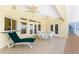 Comfortable lounge seating on a tiled patio with outdoor ceiling fans, offering a relaxing space to enjoy the weather at 233 Beeney Se Rd, Port Charlotte, FL 33952