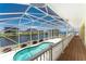 A screened-in lanai with a canal view with a pool at 233 Beeney Se Rd, Port Charlotte, FL 33952