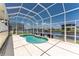 Enclosed pool in screened lanai with a clear blue sky, perfect for enjoying a refreshing swim at 233 Beeney Se Rd, Port Charlotte, FL 33952
