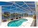 A screened-in lanai showcasing a pool with a canal view at 233 Beeney Se Rd, Port Charlotte, FL 33952