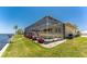 The screened lanai encloses a pool that overlooks a well-maintained lawn and canal at 233 Beeney Se Rd, Port Charlotte, FL 33952