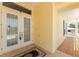 The inviting entrance features double doors, tile flooring, and a glimpse of the covered porch at 233 Beeney Se Rd, Port Charlotte, FL 33952