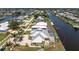 Beautiful waterfront home featuring an enclosed pool area and lush landscaping at 233 Beeney Se Rd, Port Charlotte, FL 33952