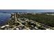 An aerial view of a charming residential neighborhood near the water, showcasing a mix of homes and lush greenery at 23476 Harper Ave, Punta Gorda, FL 33980