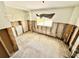 Bedroom with renovations underway, tile floors, natural light, and closet space at 23476 Harper Ave, Punta Gorda, FL 33980