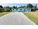 Charming single-story home featuring a light blue exterior with well-maintained landscaping at 23476 Harper Ave, Punta Gorda, FL 33980