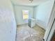 Bright laundry area featuring a window and equipped with a washing machine at 23476 Harper Ave, Punta Gorda, FL 33980