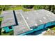 Birds-eye view of a flat roof on a well-maintained, blue home at 23476 Harper Ave, Punta Gorda, FL 33980