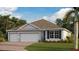 Charming one-story home with a three car garage, neutral paint, and a well-manicured lawn at 25166 Alcazar Dr, Punta Gorda, FL 33955