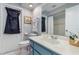Well-lit bathroom with blue vanity and ample counter space and a shower/tub combo at 26177 Madras Ct, Punta Gorda, FL 33983