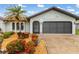 Charming exterior showcasing a well-maintained lawn and a two-car garage at 26177 Madras Ct, Punta Gorda, FL 33983