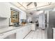 Well-lit kitchen with white cabinets, stainless steel appliances, and tile flooring at 26177 Madras Ct, Punta Gorda, FL 33983