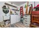 Functional laundry room equipped with a washer, dryer, sink, shelving, and storage at 26177 Madras Ct, Punta Gorda, FL 33983