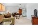 Comfortable living room featuring neutral carpeting and vaulted ceiling with dining area in view at 26177 Madras Ct, Punta Gorda, FL 33983