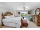 Bright main bedroom with a view of the pool, an accent chair, and a ceiling fan at 26177 Madras Ct, Punta Gorda, FL 33983
