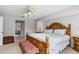 Open main bedroom boasts a wooden bed frame, an area rug, and access to the hall at 26177 Madras Ct, Punta Gorda, FL 33983