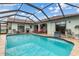 Beautiful pool area within a screened enclosure, features ample patio space and lounge chairs at 26177 Madras Ct, Punta Gorda, FL 33983