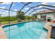 Relaxing screened pool featuring cool blue water, a seating area, and a beautiful outdoor view at 26177 Madras Ct, Punta Gorda, FL 33983