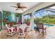 Screened patio with unique mural, ceiling fan, and access to the sparkling pool area at 26177 Madras Ct, Punta Gorda, FL 33983