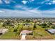 Expansive aerial view of a single-Gathering home with an enclosed backyard, outlined in red, set in a lush green community at 279 Mariner Ln, Rotonda West, FL 33947